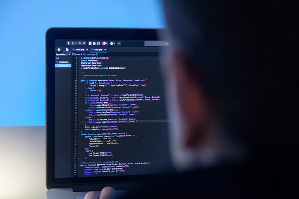 programmer working on laptop computer in office