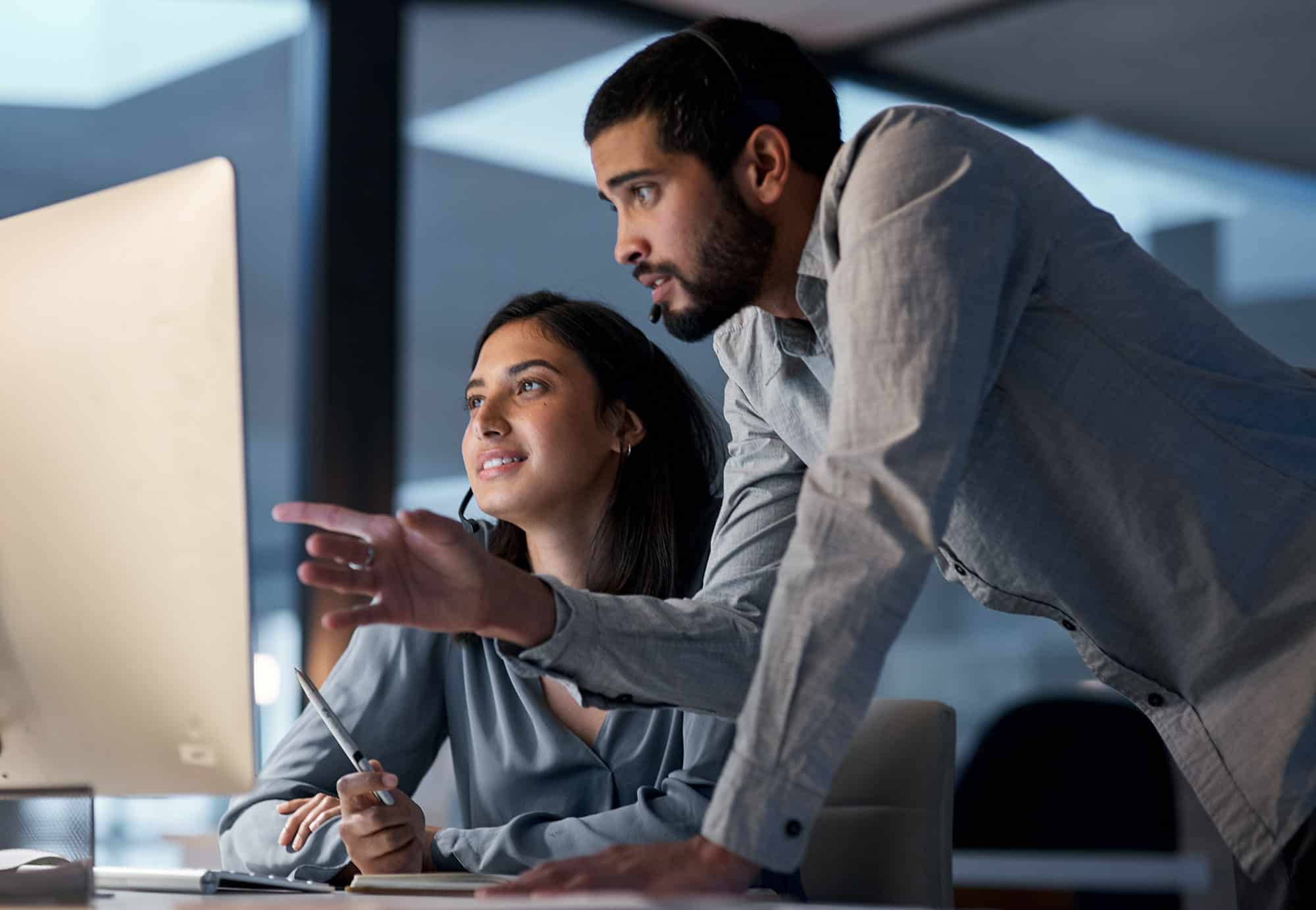 Two people looking at a computer